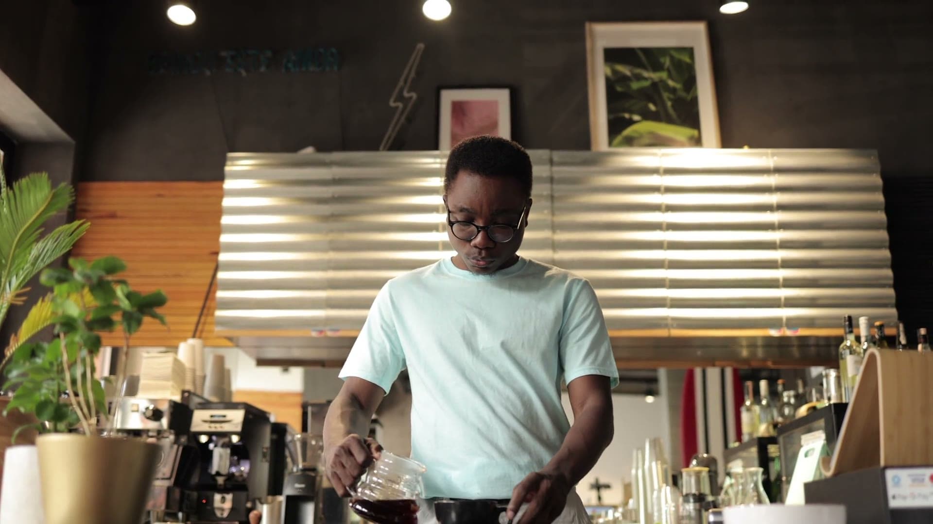 Barista pouring coffee behind a counter