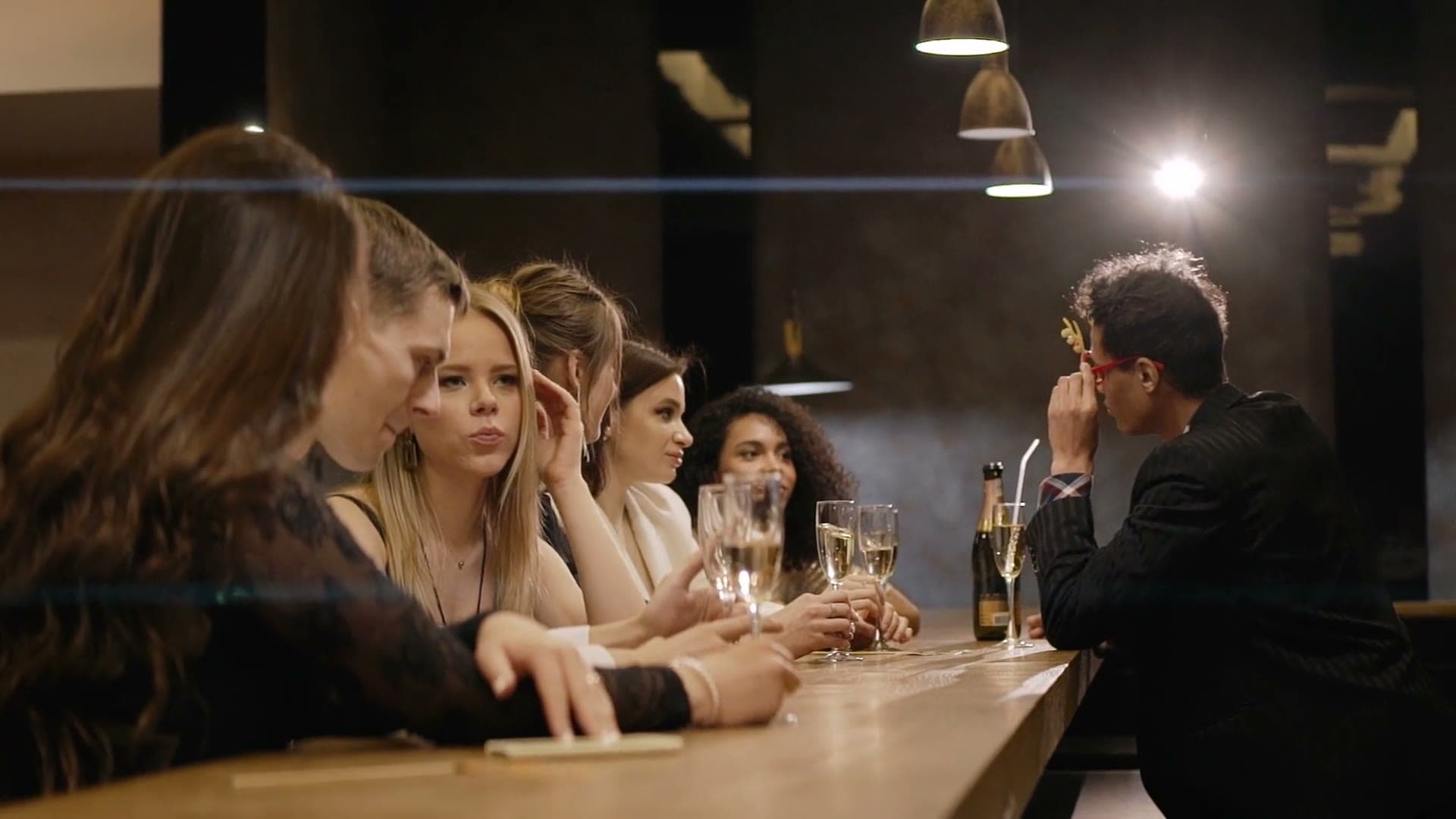Group of women at a dark bar with a bartender